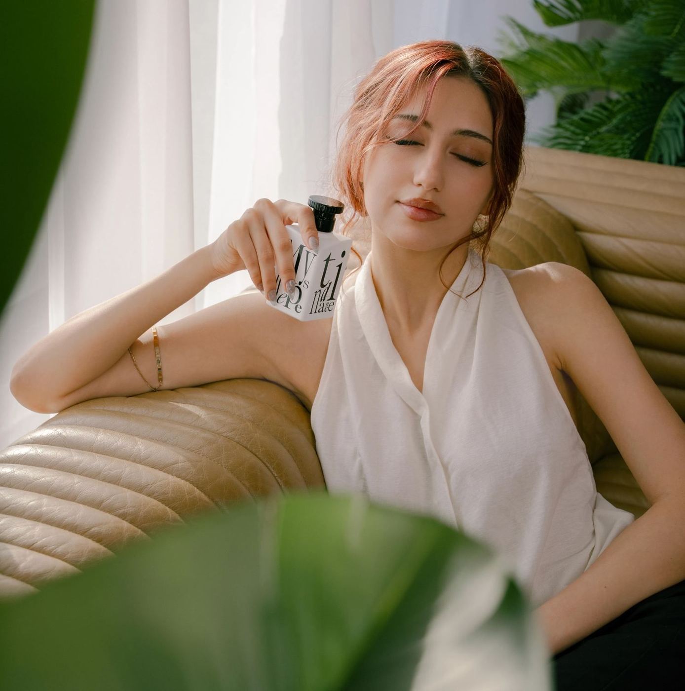 A woman holding MystiK Dépendance in afternoon light